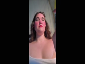 realgiantessa shows off her body and compares her thumb to a tube of lotion.