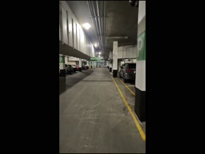 megadongx in coat walking through parking garage and building