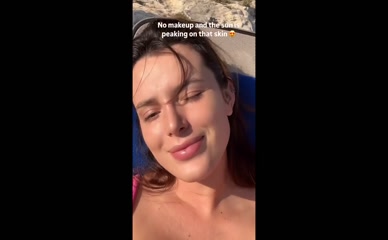Bella Thorne bikini cleavage sunbathing