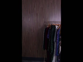 Woman models black and sequined dresses.