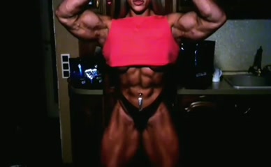 Nataliya Amazonka flexing abs and biceps.