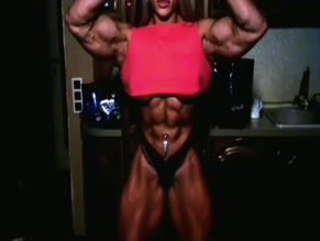 Nataliya Amazonka flexing abs and biceps.