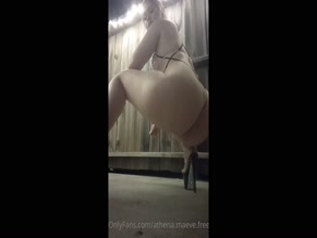 Athena Maeve in stripper heels squats in a thong.