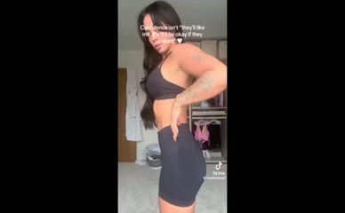Elley Davies removes skirt revealing g-string underwear and upper glutes then sports bra and cycling shorts.