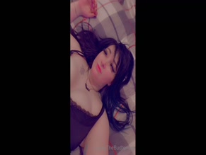 Haileythebudtender topless on bed.