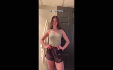 Kira Kosarin flexing biceps in tank top