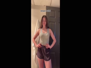 Kira Kosarin flexing biceps in tank top
