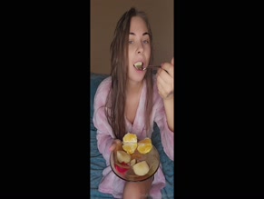 Spirigirl eats fruit in robe.