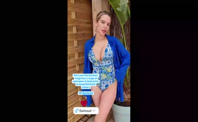 Helen Flanagan in one-piece swimsuit, prominent cleavage.
