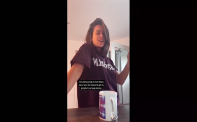 Georgia May Foote dances in t-shirt.