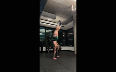 lizlovelive1995 performs handstand in athletic shorts exposing buttocks and upper thighs.