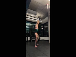 lizlovelive1995 performs handstand in athletic shorts exposing buttocks and upper thighs.