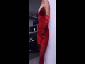 Ashley Roberts in red dress and gloves.