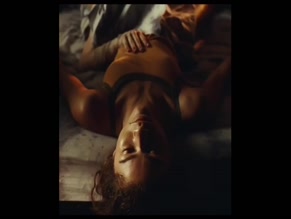 Zendaya stomach and cleavage exposed in bed with sheet over legs