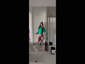 Fitronniexo's bathroom selfie in green top and thong.