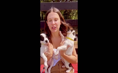 Millie Bobby Brown Holding Puppies