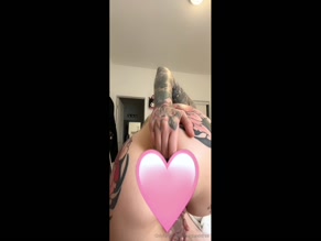 Tattooed woman fingering her asshole and using a butt plug