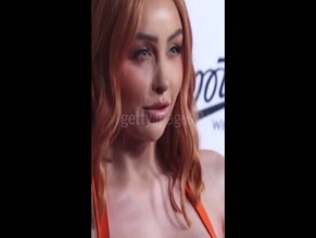 Ella MAFs hot cleavage in orange latex dress