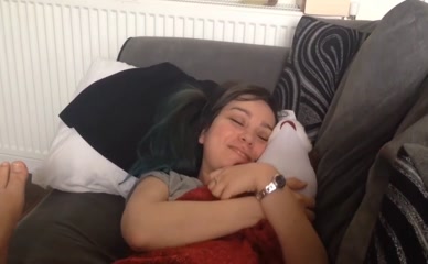 Ellen Rose lying on couch, holding plush toy