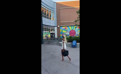 Katie Kearney golfs in a white dress.