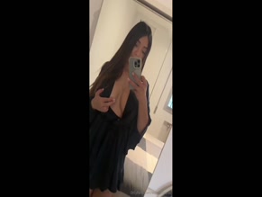 Stephanyy.xo's cleavage and legs in black dress.