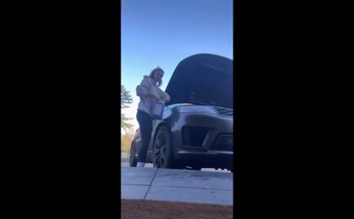 Frankie Bridge adds windshield washer fluid to car
