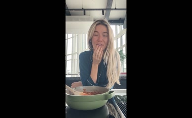 Georgia Toffolo cooking in unbuttoned pajamas.