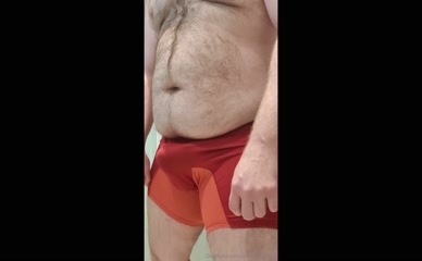 Man in underwear adjusting bulge.