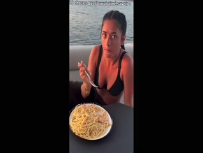 Miel Abt eating pasta in sexy black bikini