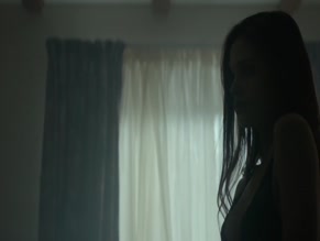 India Eisley's bare breasts in a bathtub, doctor's office, and bedroom.