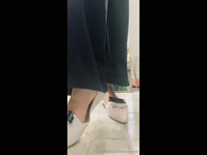 Servingvelvet bare foot dangling from shoe close up