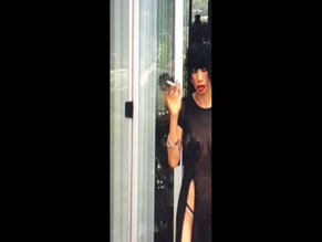Bai Ling nude smoking in sheer dress.