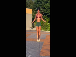 Morgane Herculano flexing and exercising in a bikini top and tight shorts