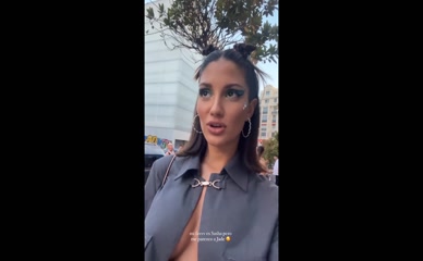 Tania Medina's tits slip out of her open shirt.