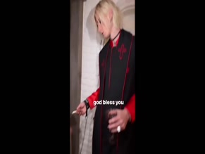 Megan Fox kneeling, licking lollipop