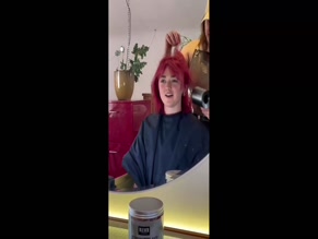 Maisie Williams: Hair salon video, no explicit exposure.