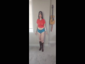 Woman in Wonder Woman cosplay dances in underwear.