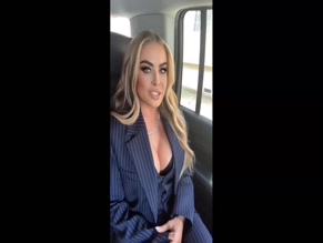 Carmen Electra cleavage in pinstripe suit