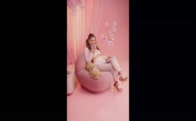 Millie Bobby Brown sitting in pink room with dog