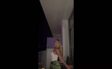 Daisy Campbell dances in a tank top.