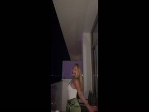 Daisy Campbell dances in a tank top.