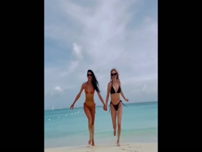 Heather Graham and friend running in bikinis on beach