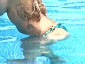 Jodie Marsh topless pool striptease.