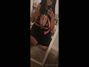 Yeonnie's large breasts spilling out of black bikini top