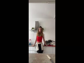 Celina in red top and black and white pants.