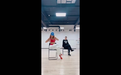 Rita Ora dance rehearsal red top white pants.