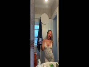 Daisy Campbell bathroom selfie cleavage tease.