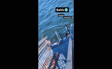 Rebecca Sarker in black swimsuit exiting Baltic Sea
