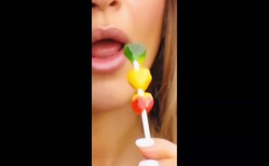 Rita Ora close-up mouth sucking gummy candy