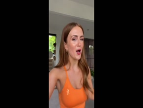 Maisie Smith Orange Sports Bra Cleavage